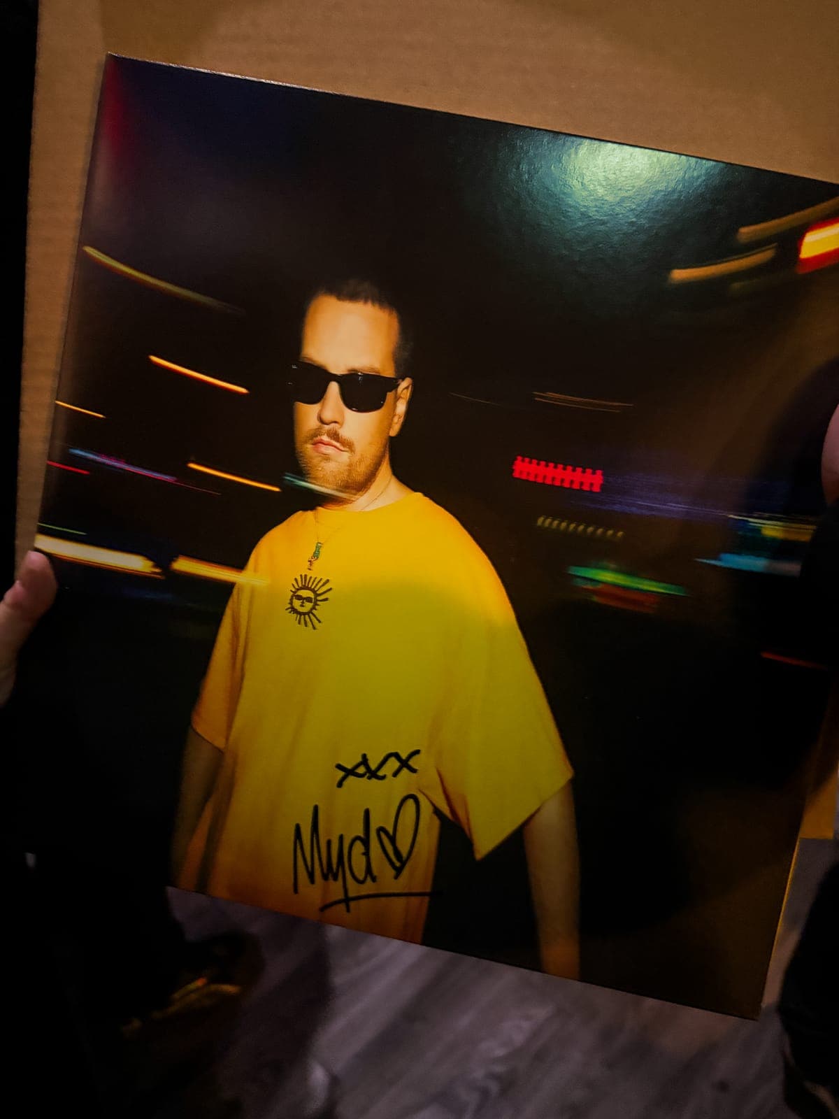Close-up of a Myd print signed 'xxx Myd' with a heart