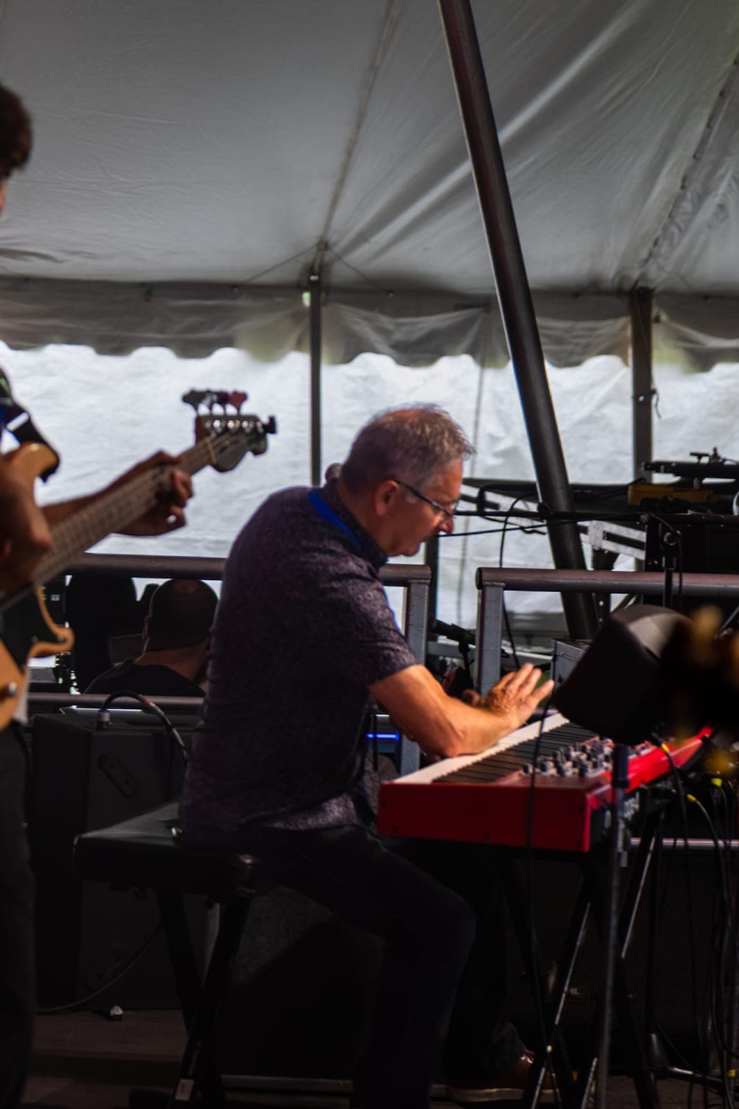 Isy Aboagye's keyboardist slams his forearm down across the red Nord keyboard in a showman's flourish at Kitchener Blues Festival