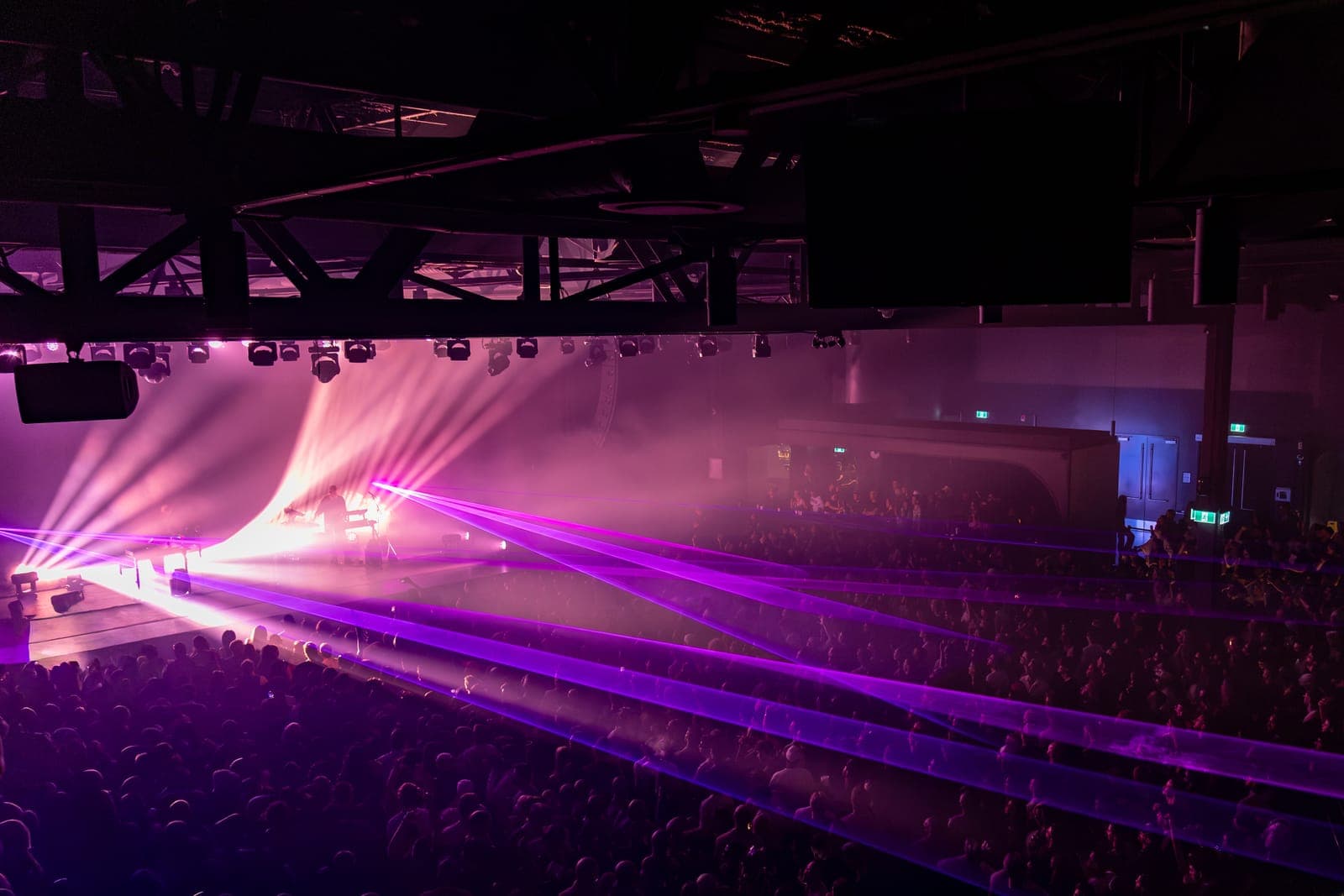 Magenta lasers sweep the length of HISTORY's floor and balcony, the room packed for Tinlicker