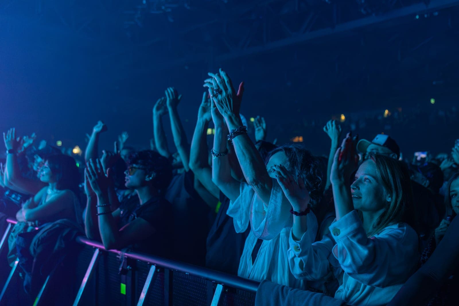 Hands go up along the front barricade at HISTORY as Tinlicker's set washes the room in deep blue