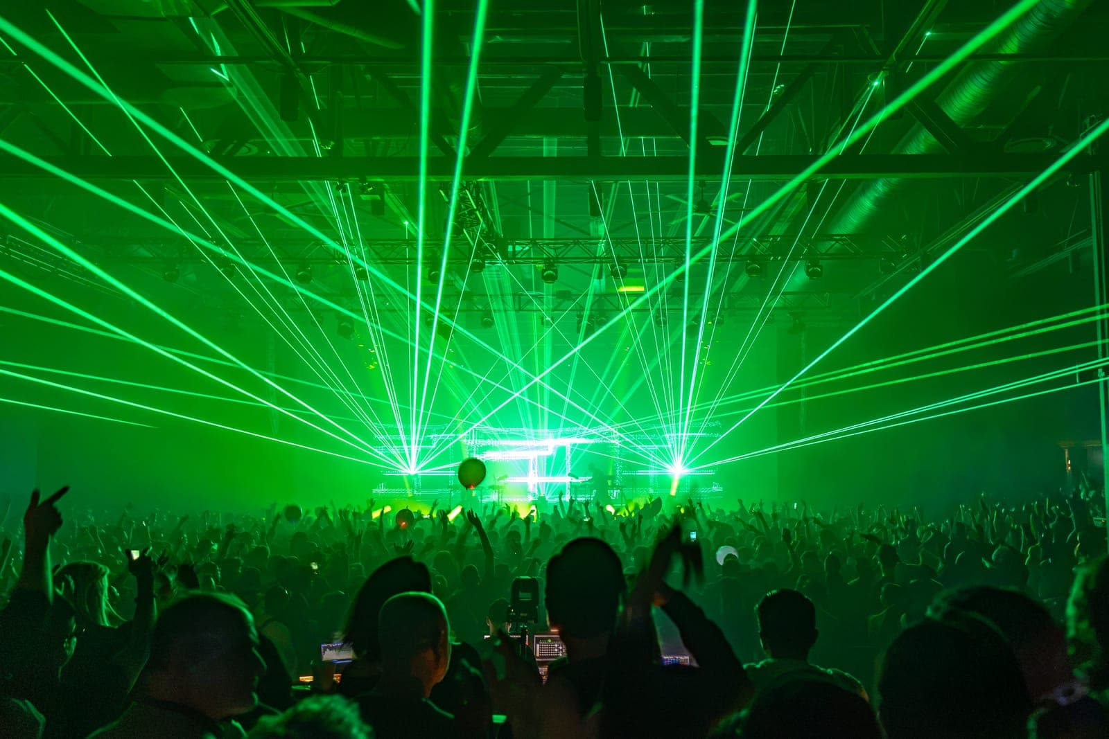 Green lasers fan the full width of HISTORY's warehouse ceiling and out over the crowd during Tinlicker's Toronto show