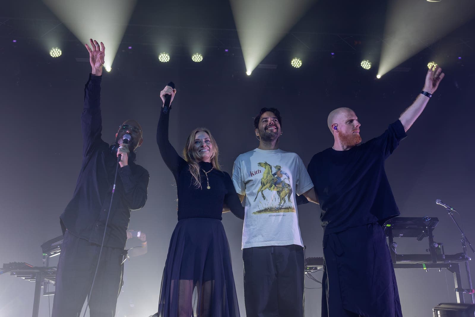 Tinlicker's Micha Heyboer, Hero Baldwin and Jordi van Achthoven, left to right, link arms with Helsloot and raise their hands for a bow at the end of the night at HISTORY Toronto