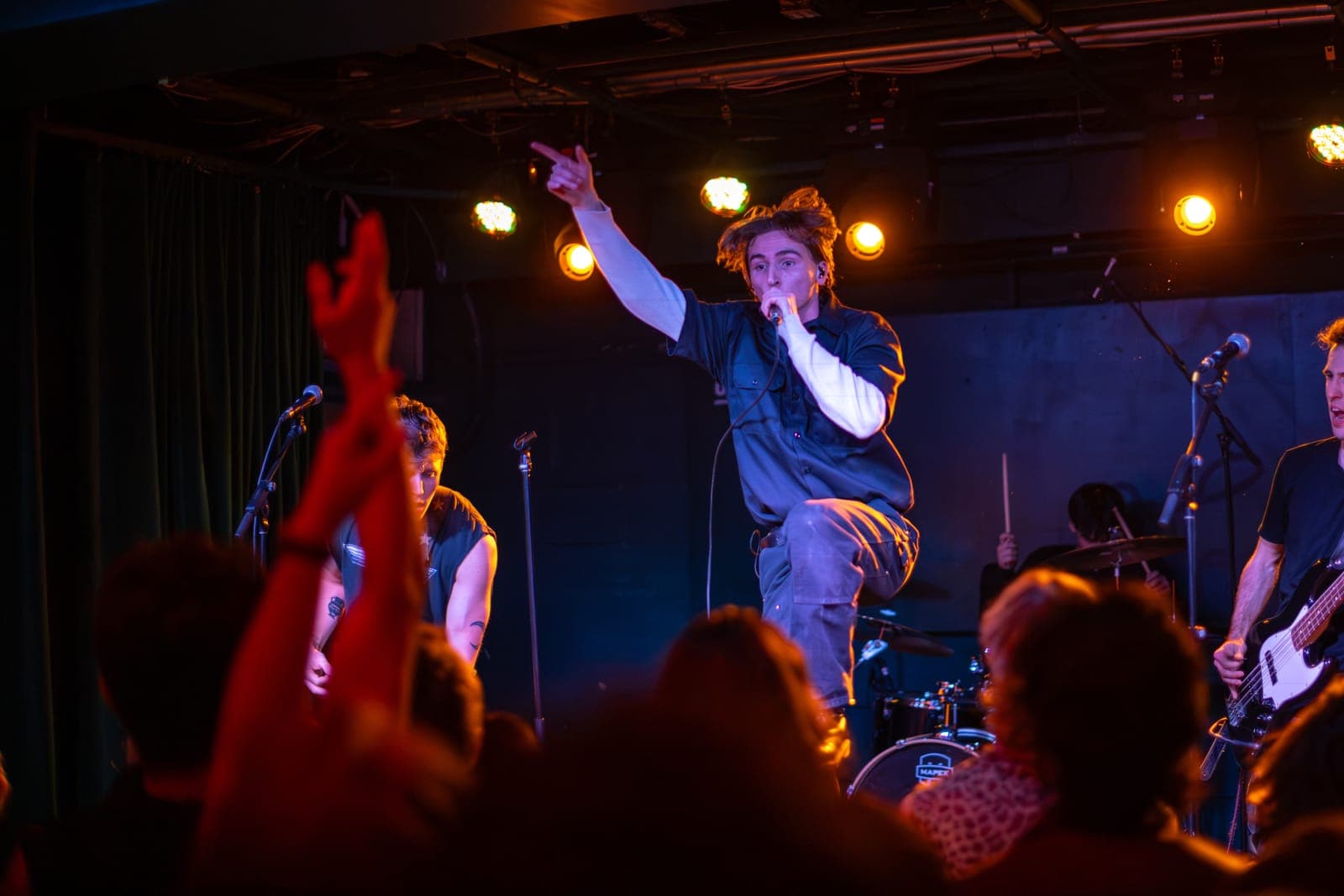 Black Pontiac's singer points skyward with one knee raised mid-song as the Toronto crowd's hands fly up at The Drake Underground