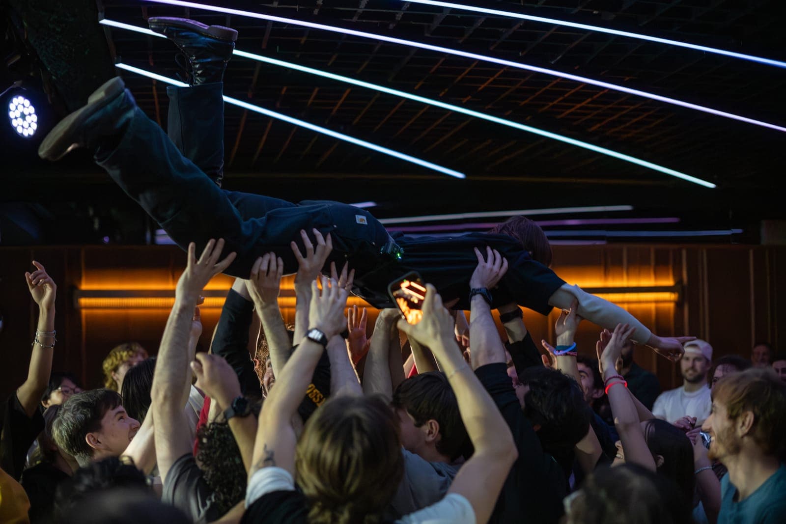A fan crowd-surfs over a sea of raised hands during Black Pontiac's set at The Drake Underground in Toronto