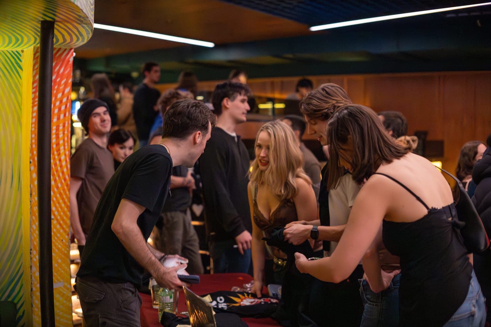 Fans mingle at the merch table after Black Pontiac's show at The Drake Underground, Toronto