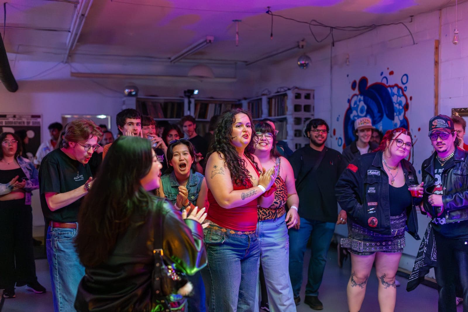 City Builders fans sing along in the crowd of the intimate, pink-lit room at Division 88 in Toronto
