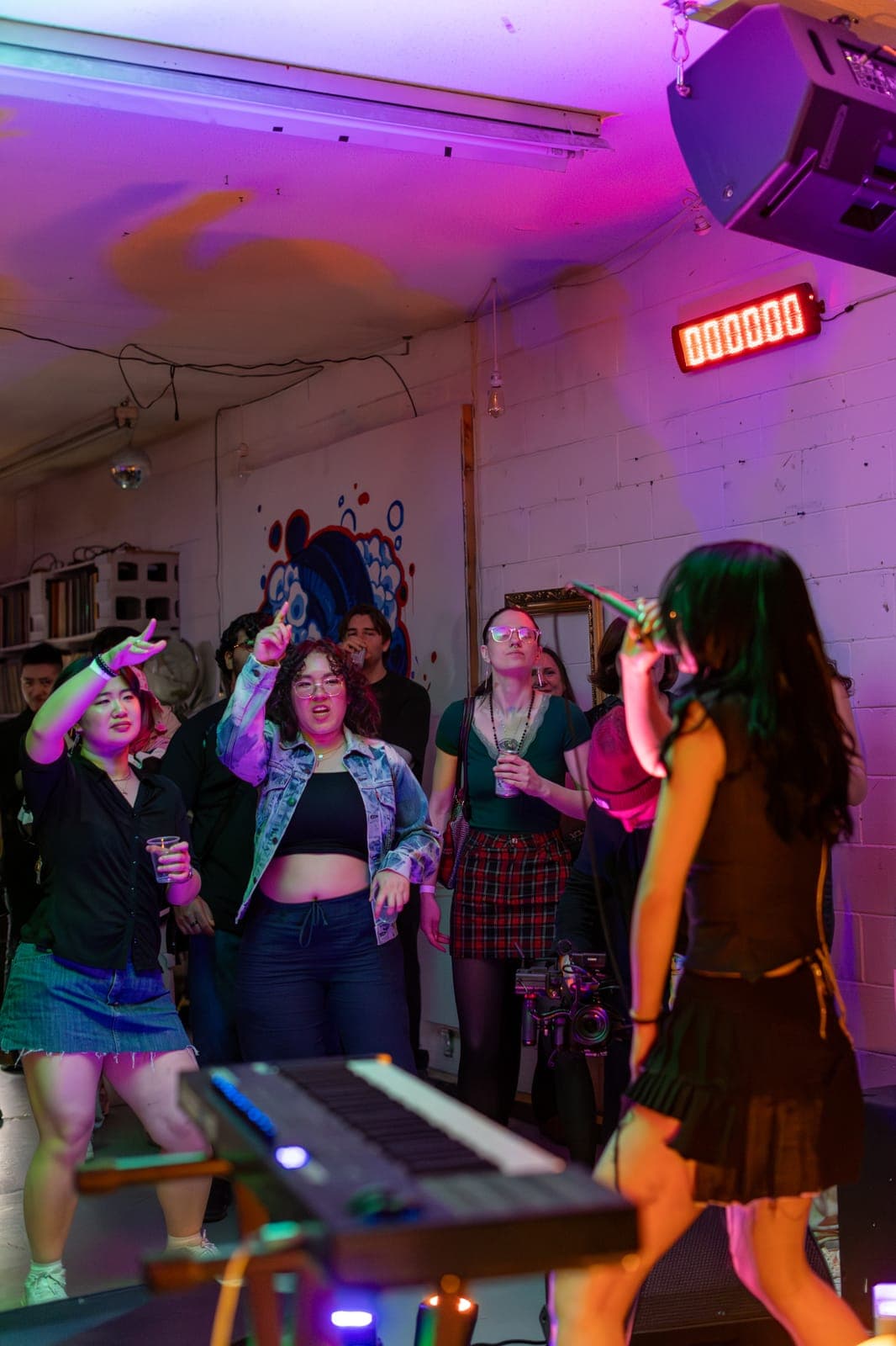 City Builders' vocalist faces a dancing crowd with hands in the air at Division 88 in Toronto
