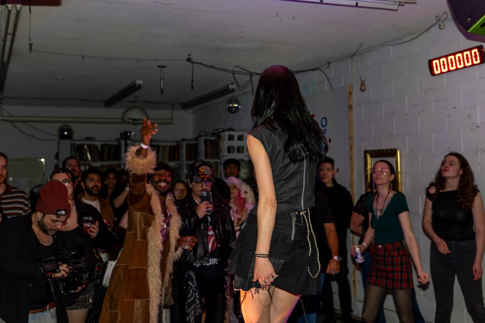 City Builders' vocalist faces the cheering crowd, a fan pointing back, at Division 88 in Toronto