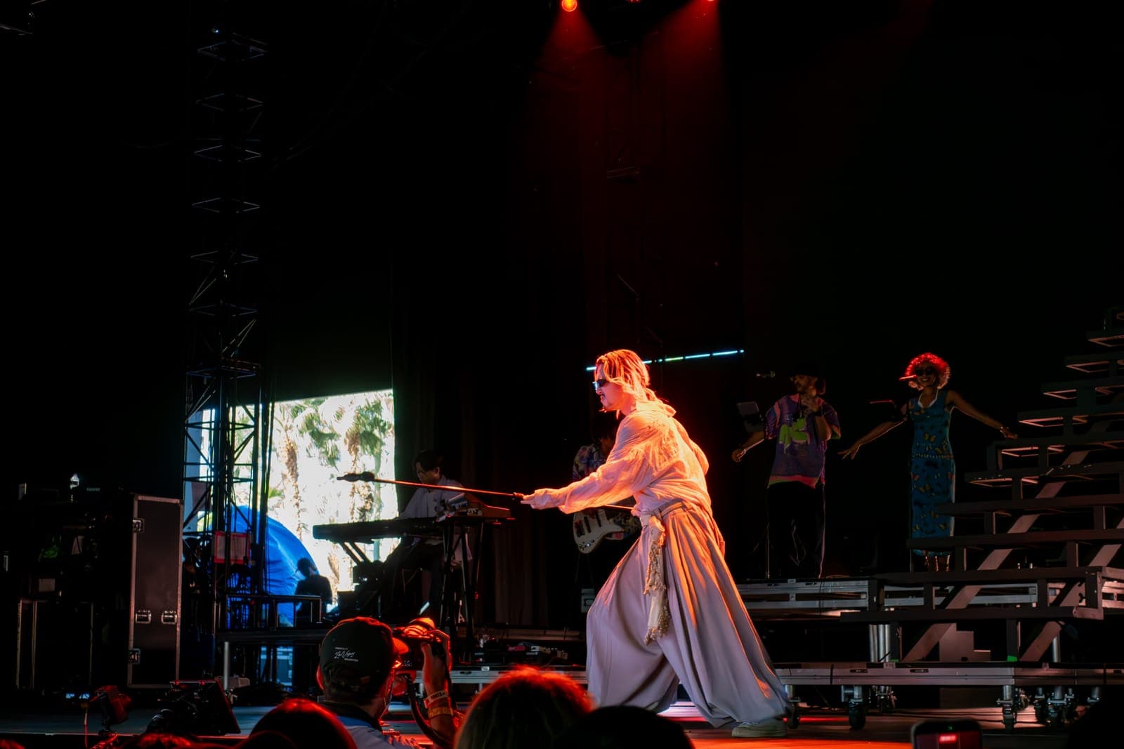 Fujii Kaze moves across the stage in flowing robes mid-performance at Coachella, Empire Polo Club in Indio