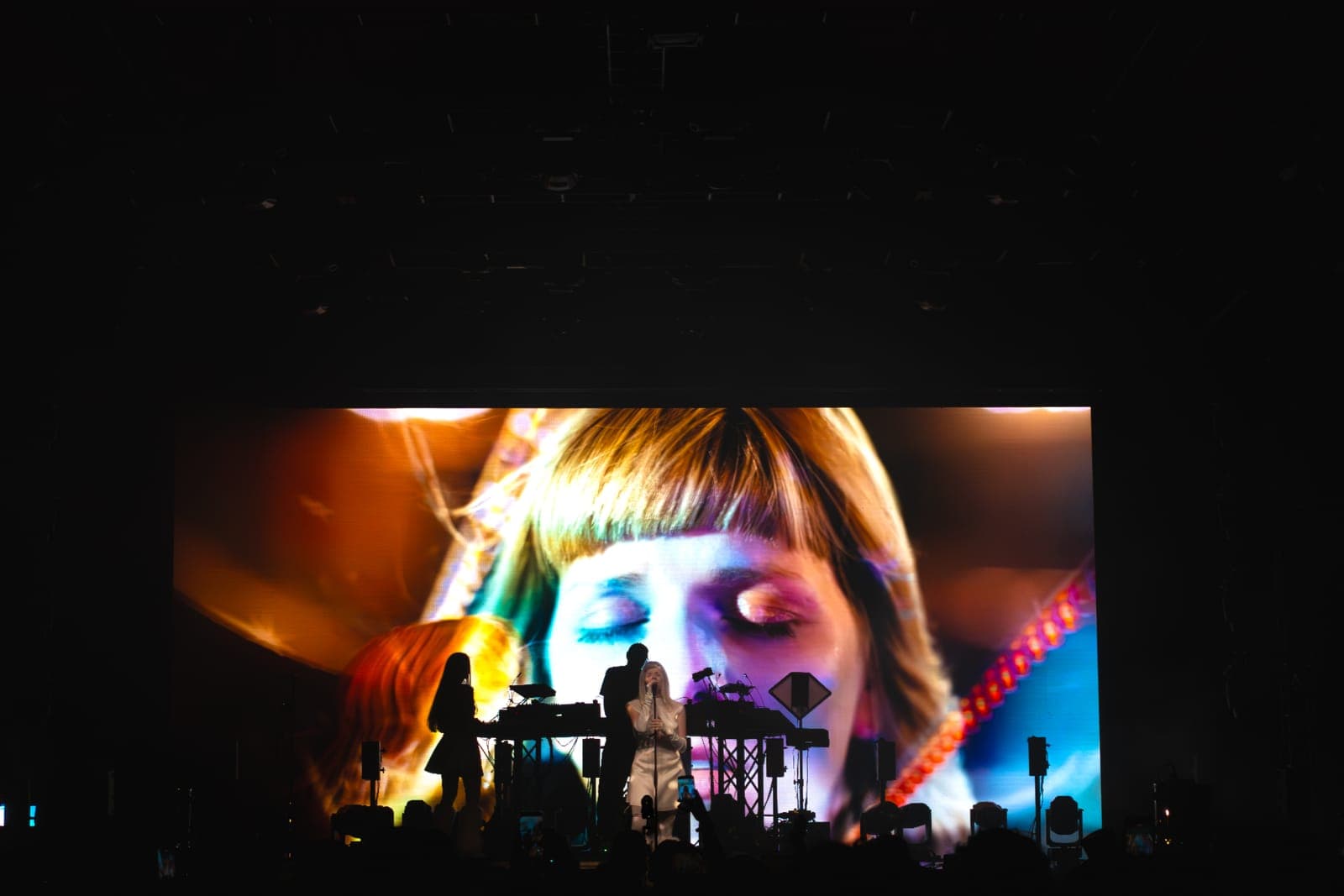 Tomora performs in front of a giant screen showing a close-up of her face at Coachella, Indio