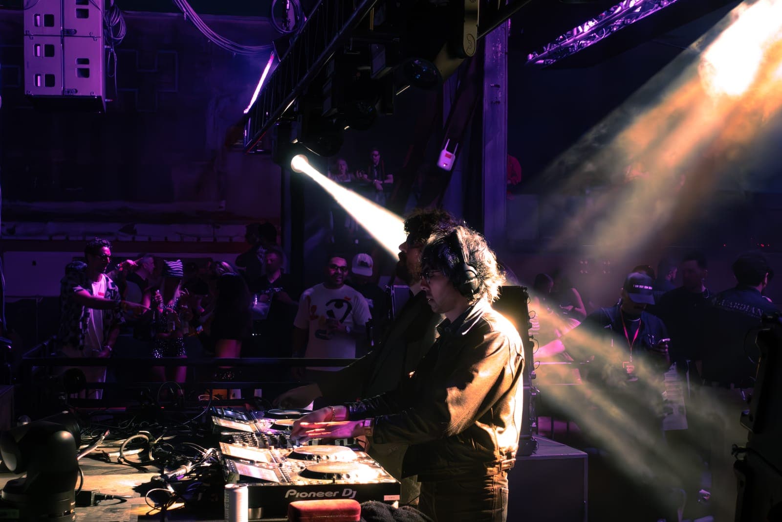 Justice perform behind the DJ decks under a single piercing spotlight at Factory Town in Miami