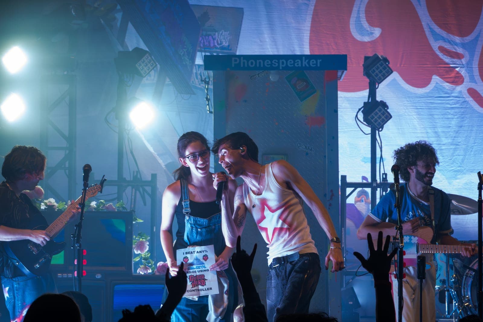Good Kid's singer laughs with a fan brought onstage holding a certificate at Danforth Music Hall in Toronto