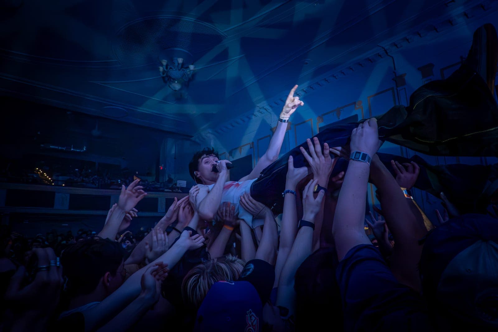 Good Kid's singer crowd-surfs while singing, held aloft beneath the ornate Danforth Music Hall ceiling in Toronto