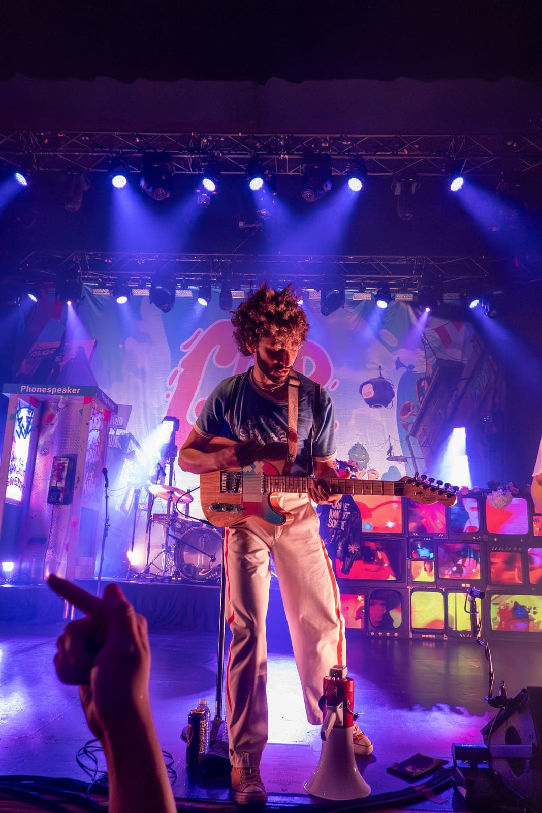 Good Kid's guitarist plays before a glowing wall of TV screens at Danforth Music Hall in Toronto