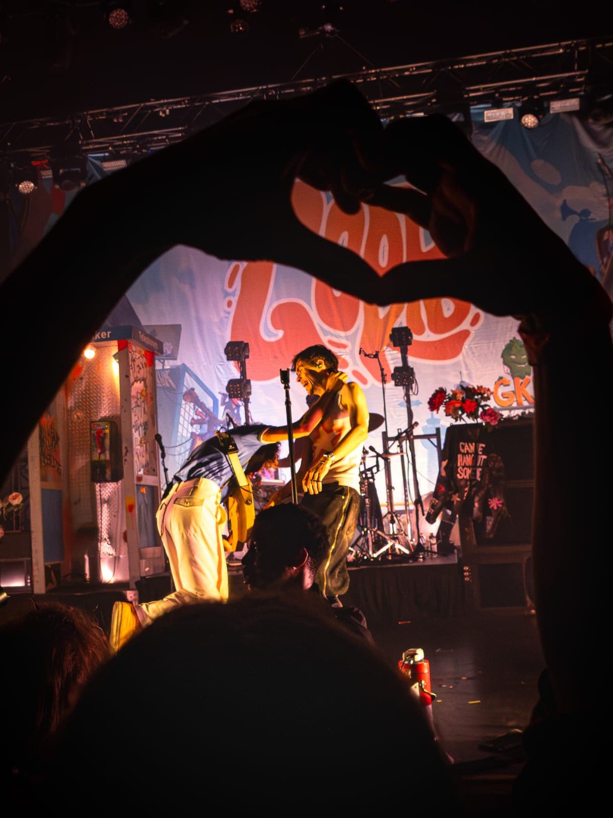 A fan's hands form a heart around Good Kid's singer on the warmly lit stage at Danforth Music Hall, Toronto