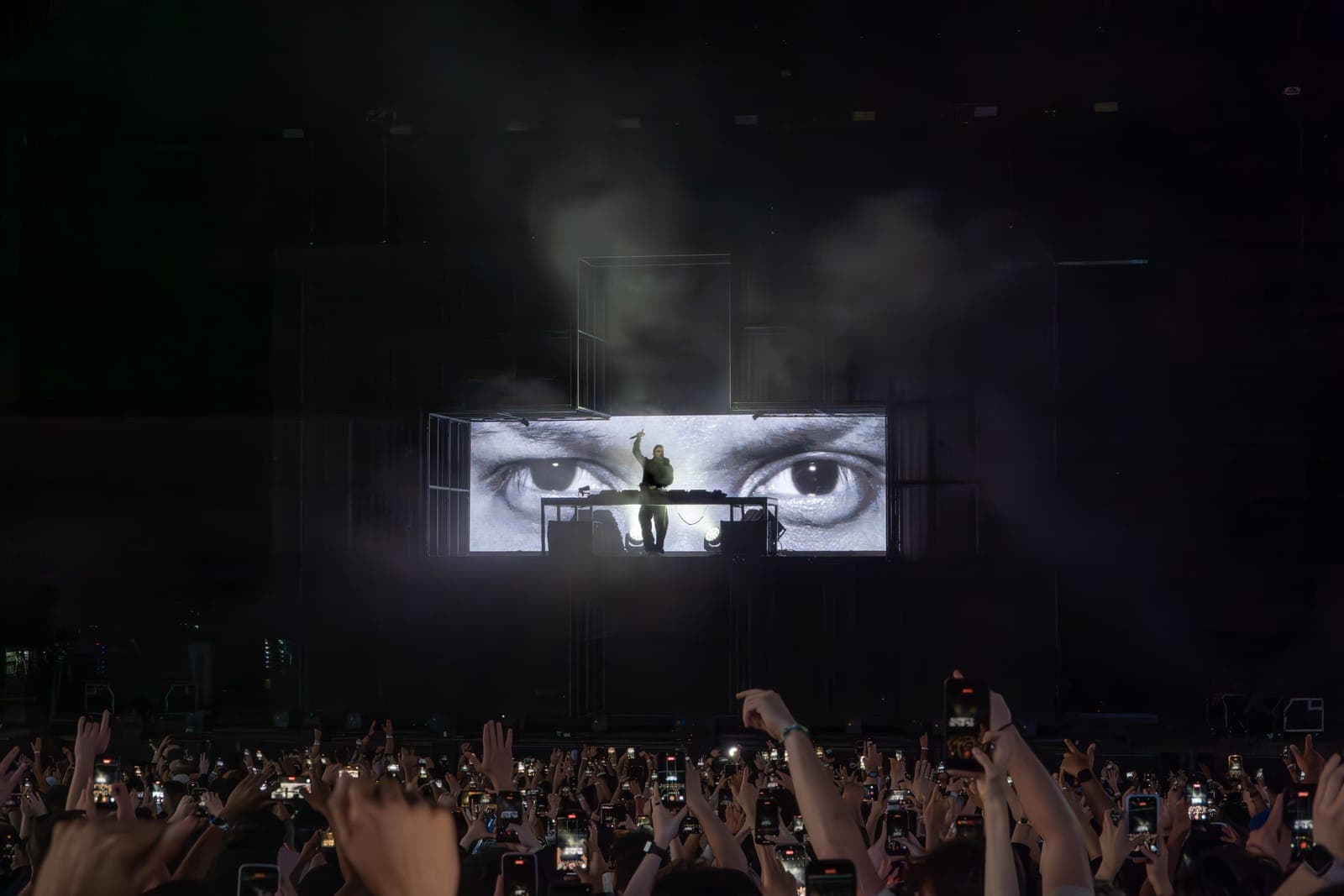 Martin Garrix performs as a giant close-up of his eyes fills the screen above a sea of phones at RBC Amphitheatre in Toronto