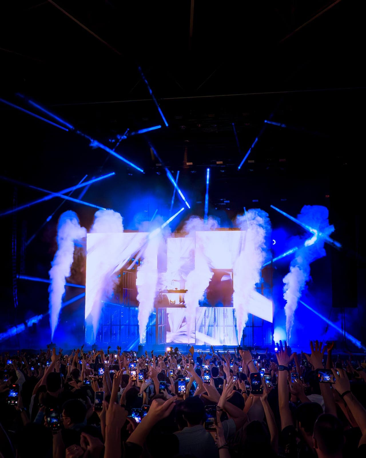 White CO2 jets and blue beams erupt around the stage as the crowd films Martin Garrix at RBC Amphitheatre, Toronto
