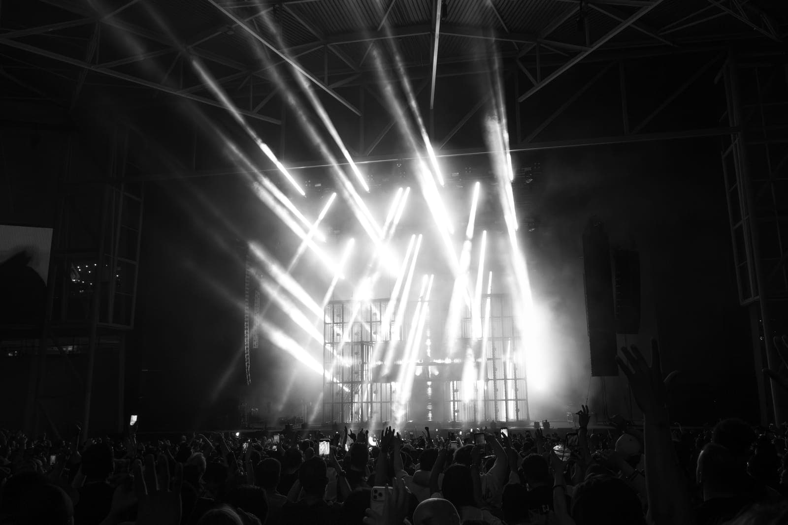 Black-and-white beams of light fan over the crowd during Martin Garrix's set at RBC Amphitheatre in Toronto