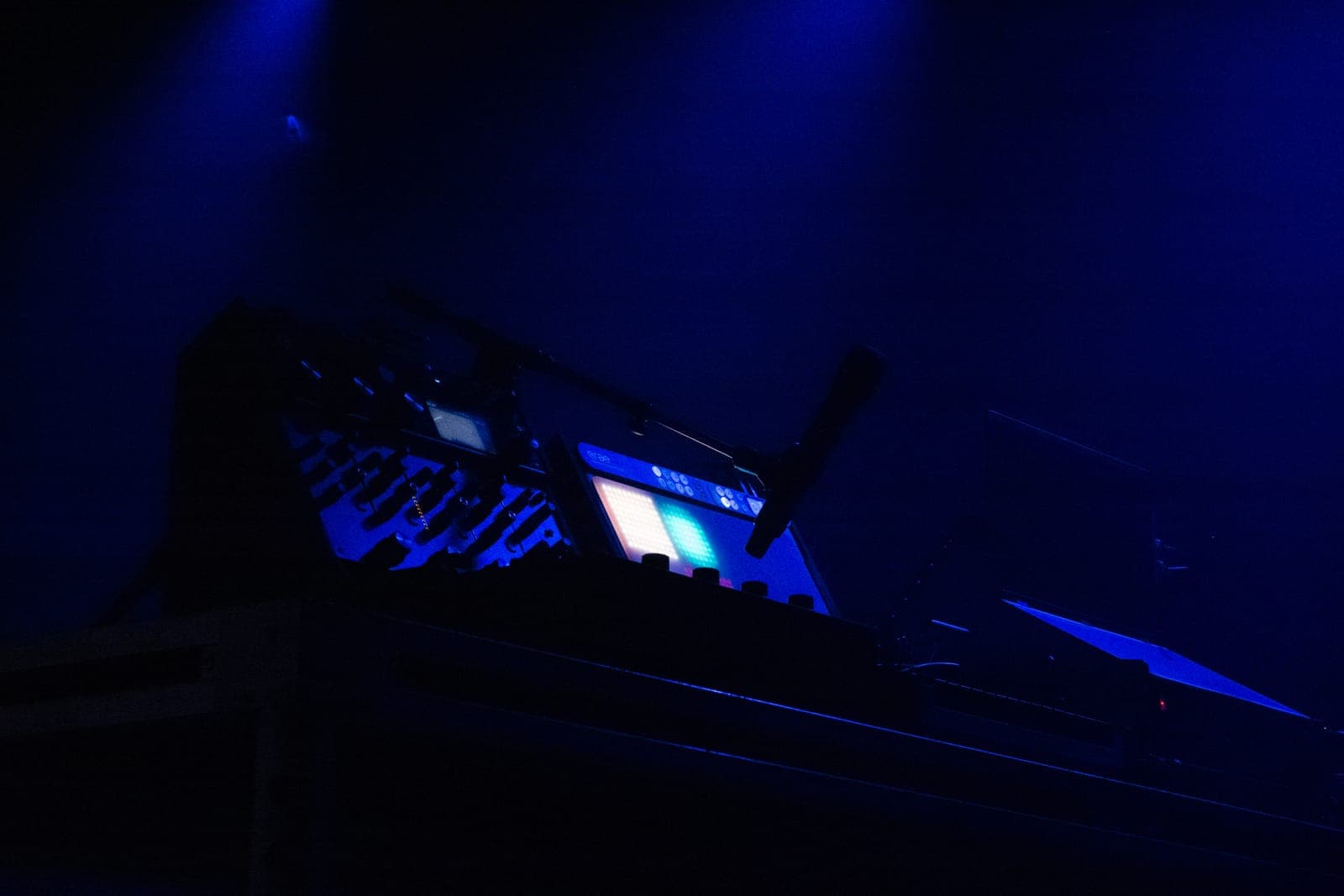Close-up of Myd's glowing synth and sampler in the blue darkness at The Mod Club in Toronto