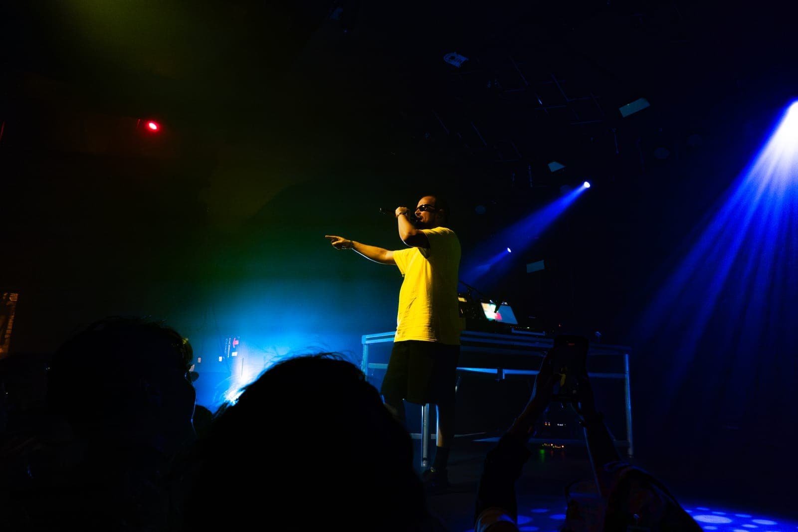 Myd points to a fan mid-song amid green and blue light at The Mod Club in Toronto