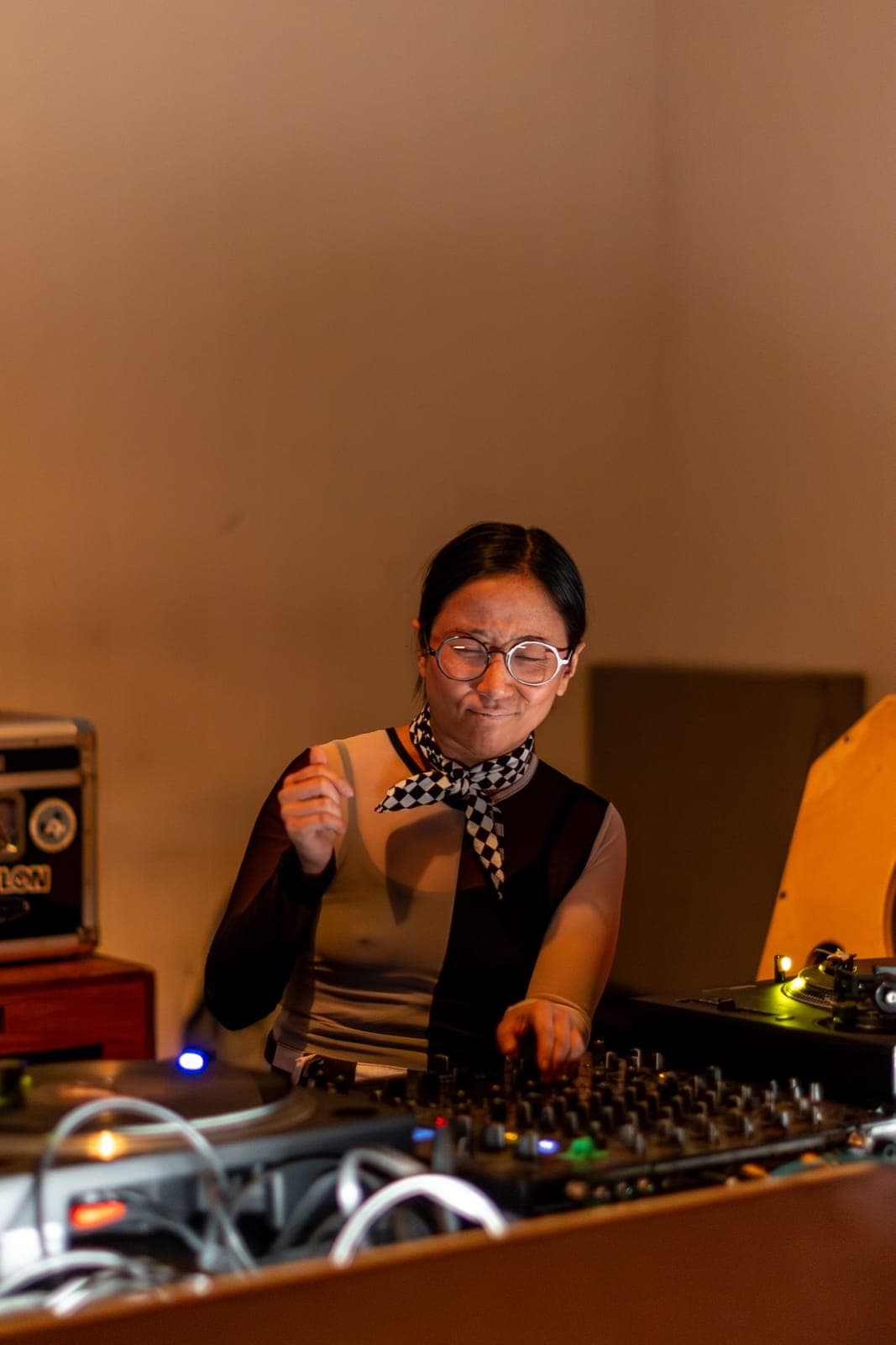 sadstab mixes with focus behind the turntables in a checkered scarf at Standard Time in Toronto