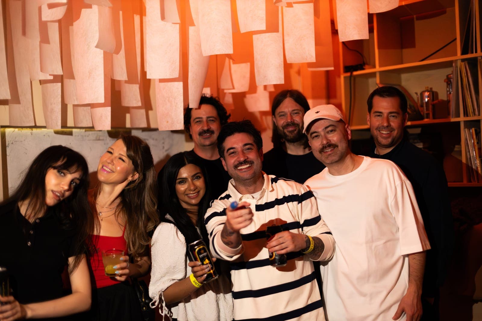 The Sapporo Live crew and friends pose together under paper lanterns at Standard Time in Toronto