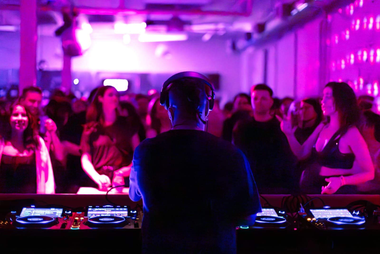 Felix Da Housecat faces a packed crowd from behind the decks under pink light at Standard Time in Toronto