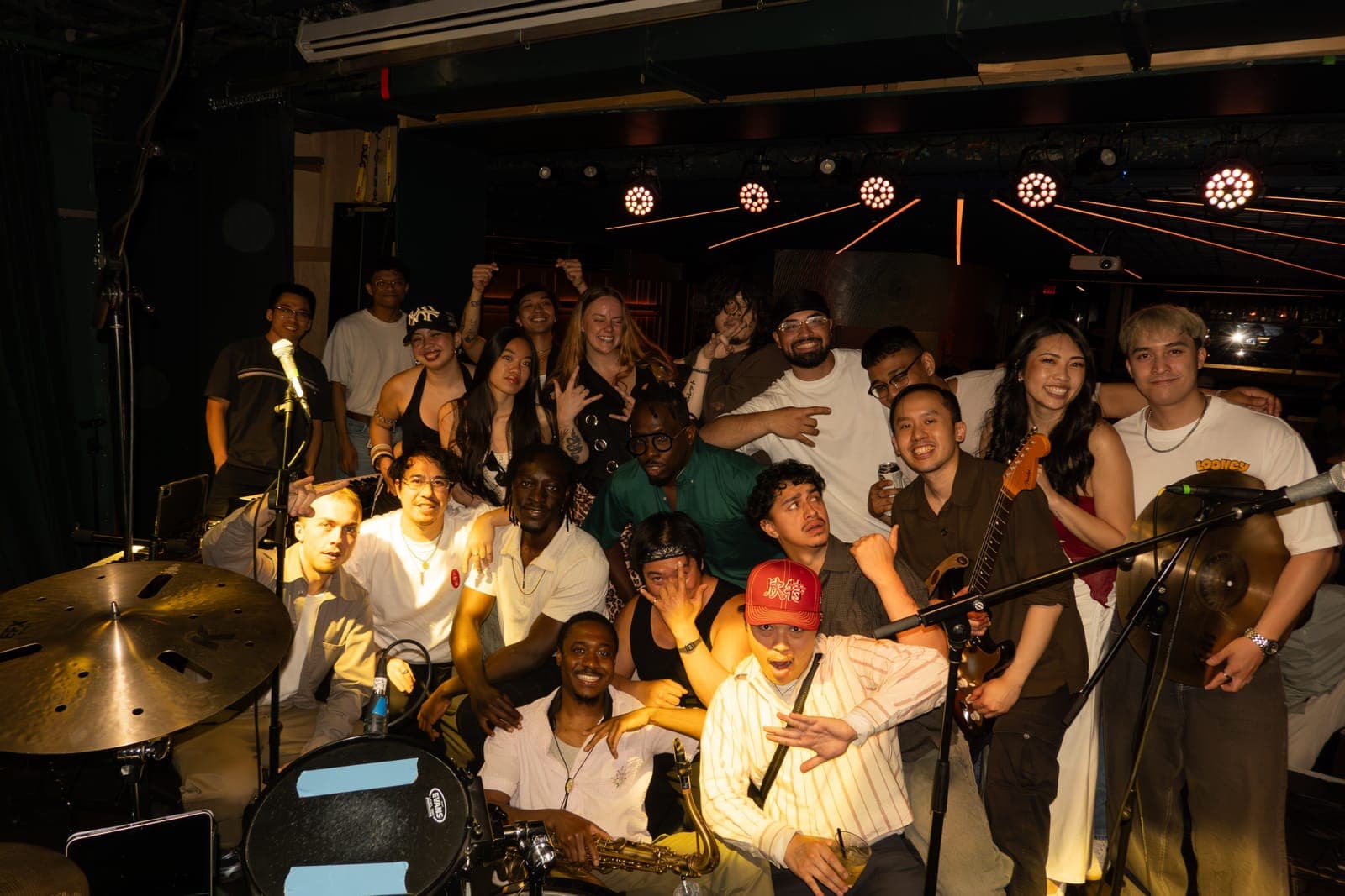 The full Takes a Village collective pose together on stage at their album release at The Drake Underground in Toronto
