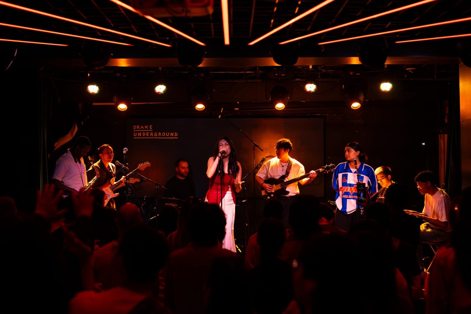 Takes a Village perform a full-band set as their vocalist leads at the mic at The Drake Underground in Toronto