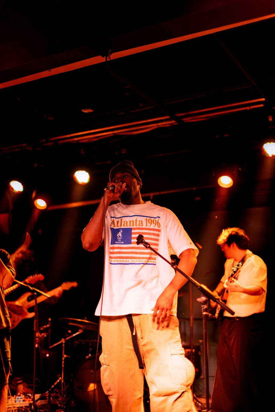A Takes a Village vocalist raps into the mic in an 'Atlanta 1996' tee at The Drake Underground in Toronto