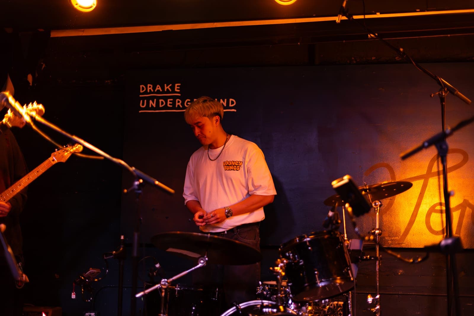 A Takes a Village drummer at the kit beneath the Drake Underground sign in Toronto