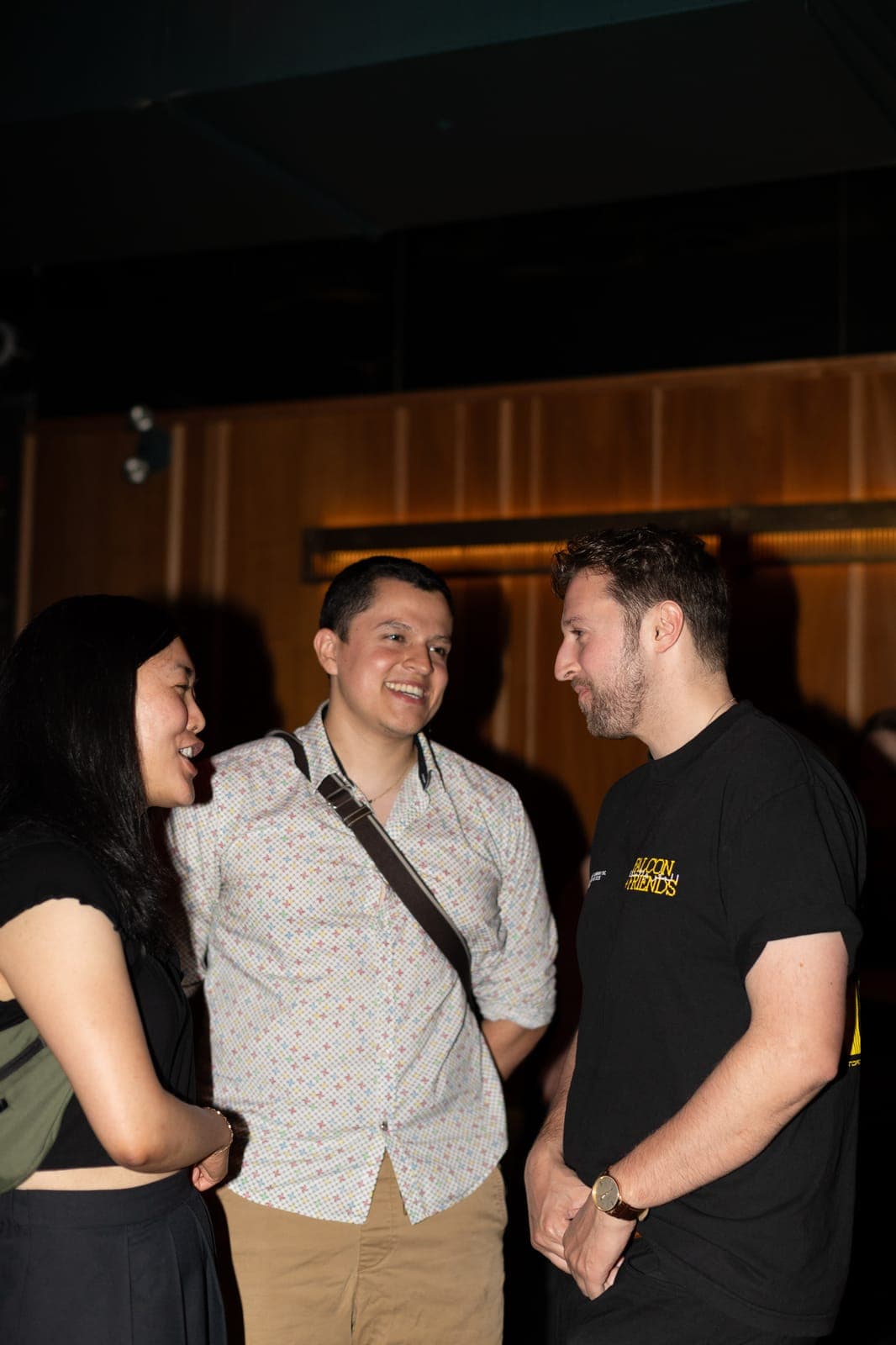 Friends chat in the wood-panelled lobby after the Takes a Village album release at The Drake Underground in Toronto