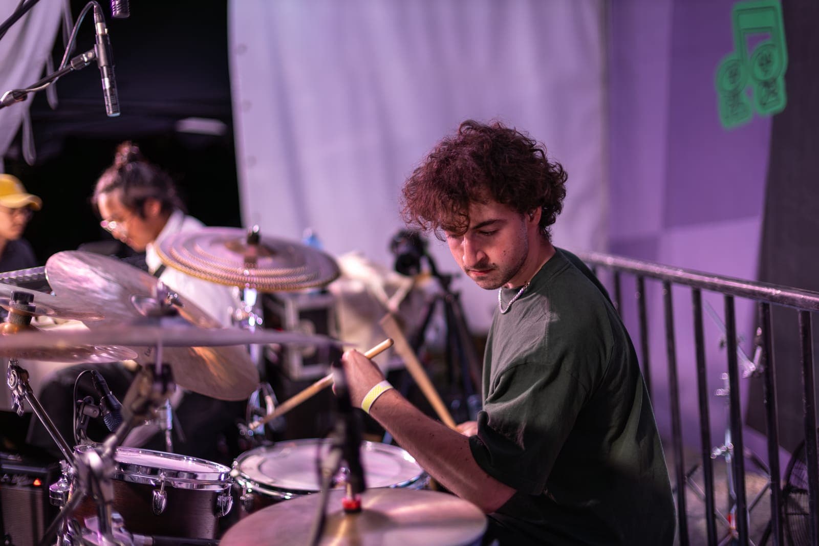 Duck Society's drummer digs into a groove behind the kit, a bandmate blurred at the edge of the frame