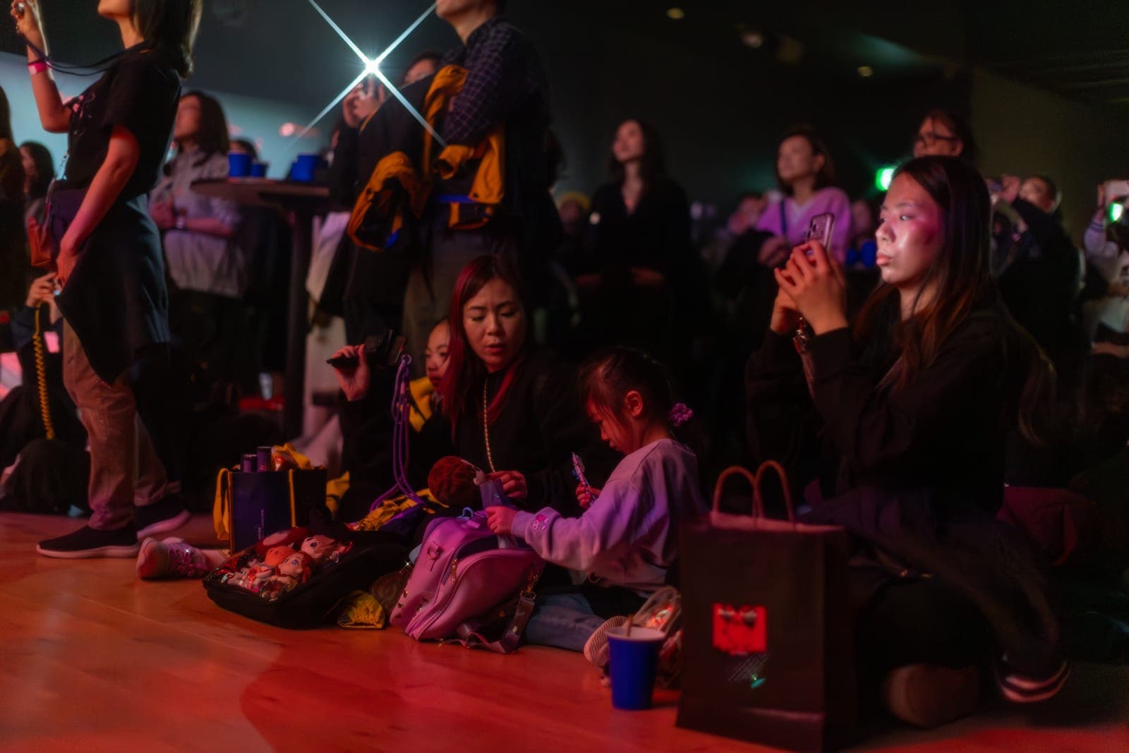 Fans and a young child sit at the back of the hall during the Keung To fan event at TD Music Hall in Toronto