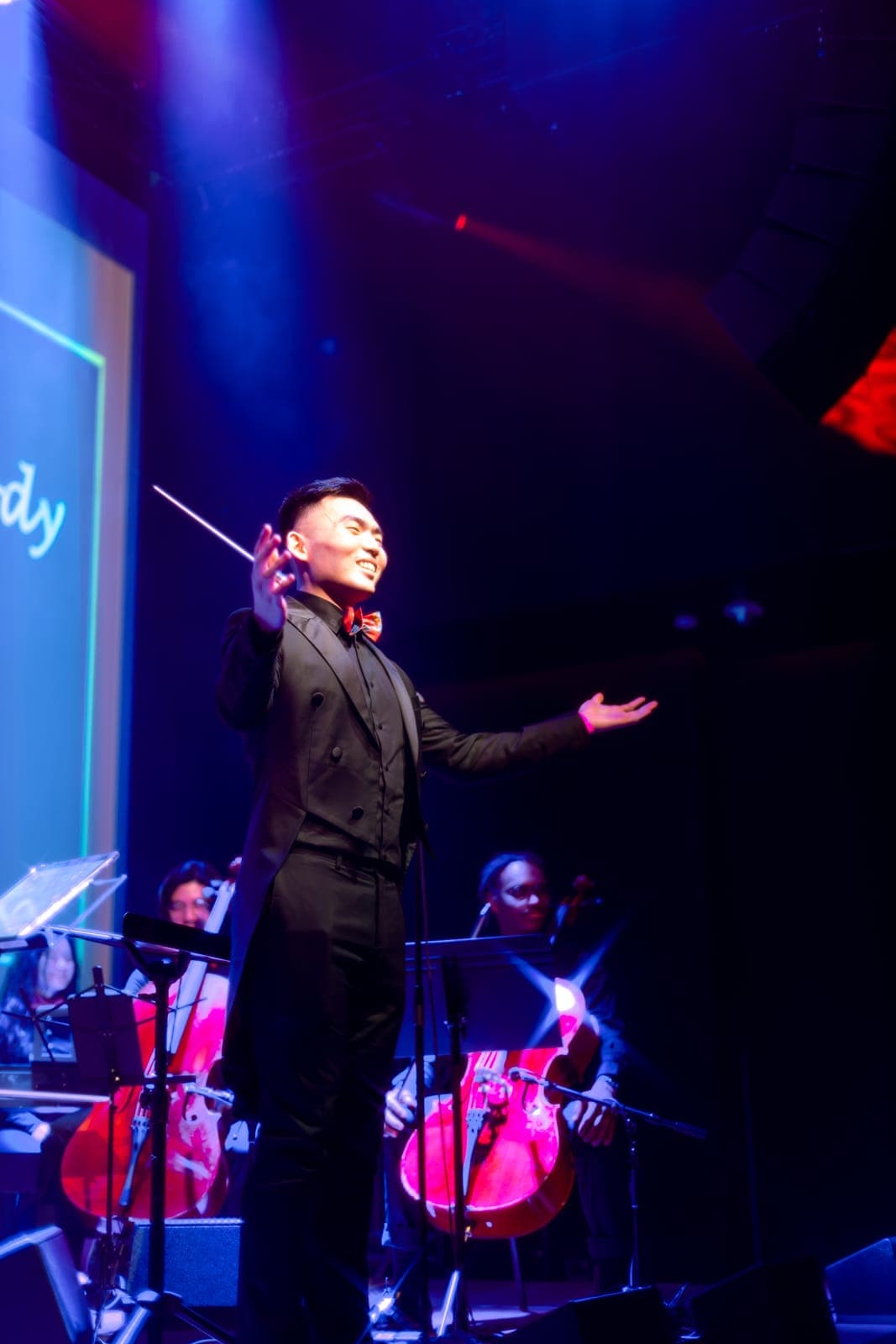 The conductor smiles mid-flourish leading the Toronto Pops Orchestra at the Keung To fan event at TD Music Hall in Toronto