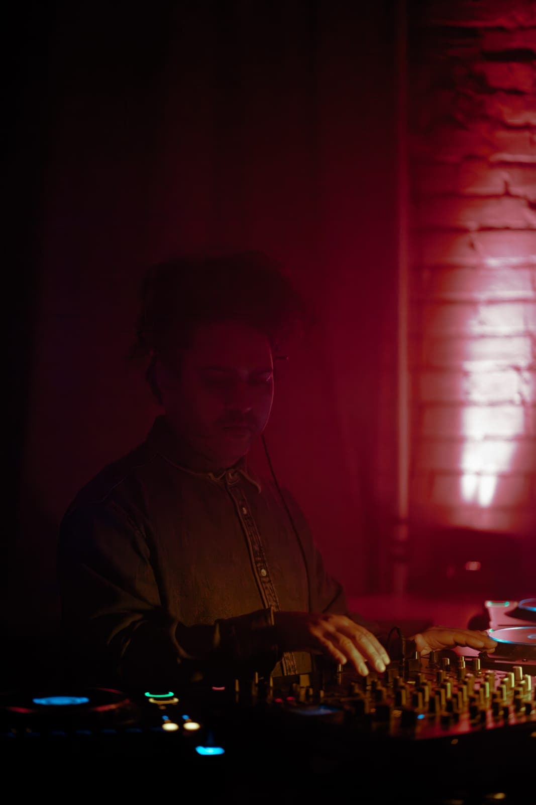 Nitin mixes in a denim shirt amid dreamy red light at Rhythm in Toronto