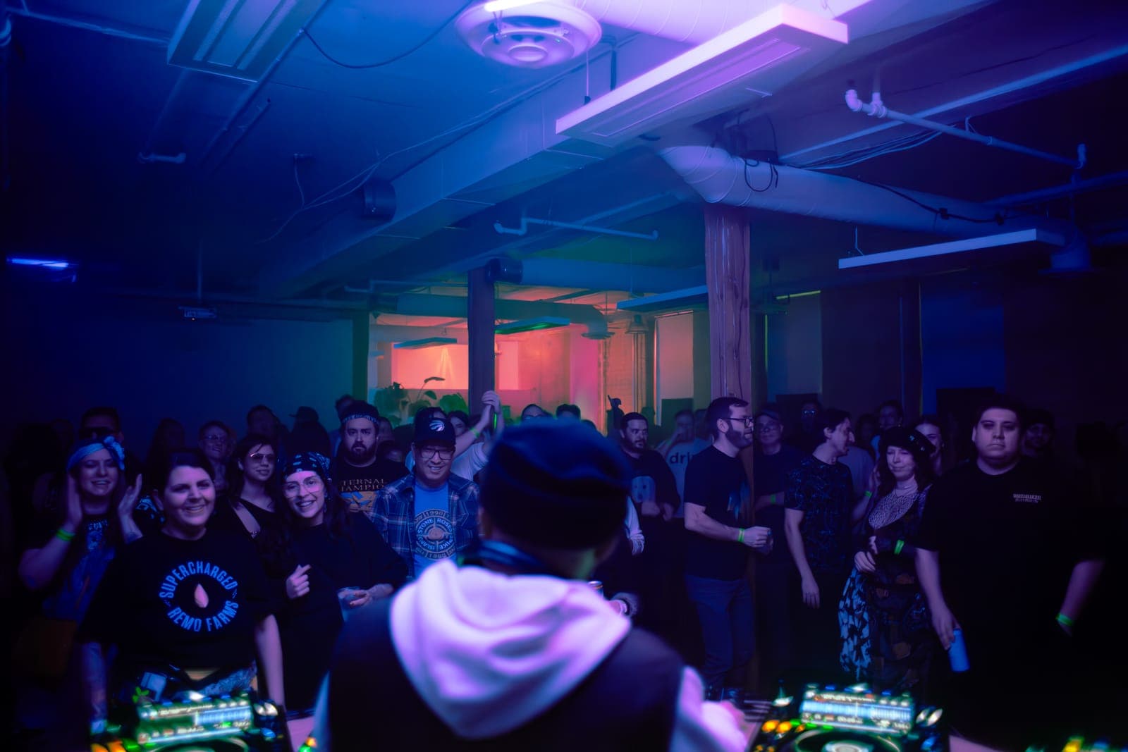 Pat Lok faces the crowd from behind the decks in the industrial room at Rhythm in Toronto