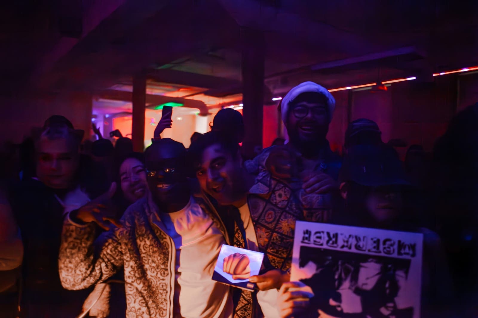 Fans grin and hold up an MSTRKRFT record during Al-P's set at Rhythm in Toronto