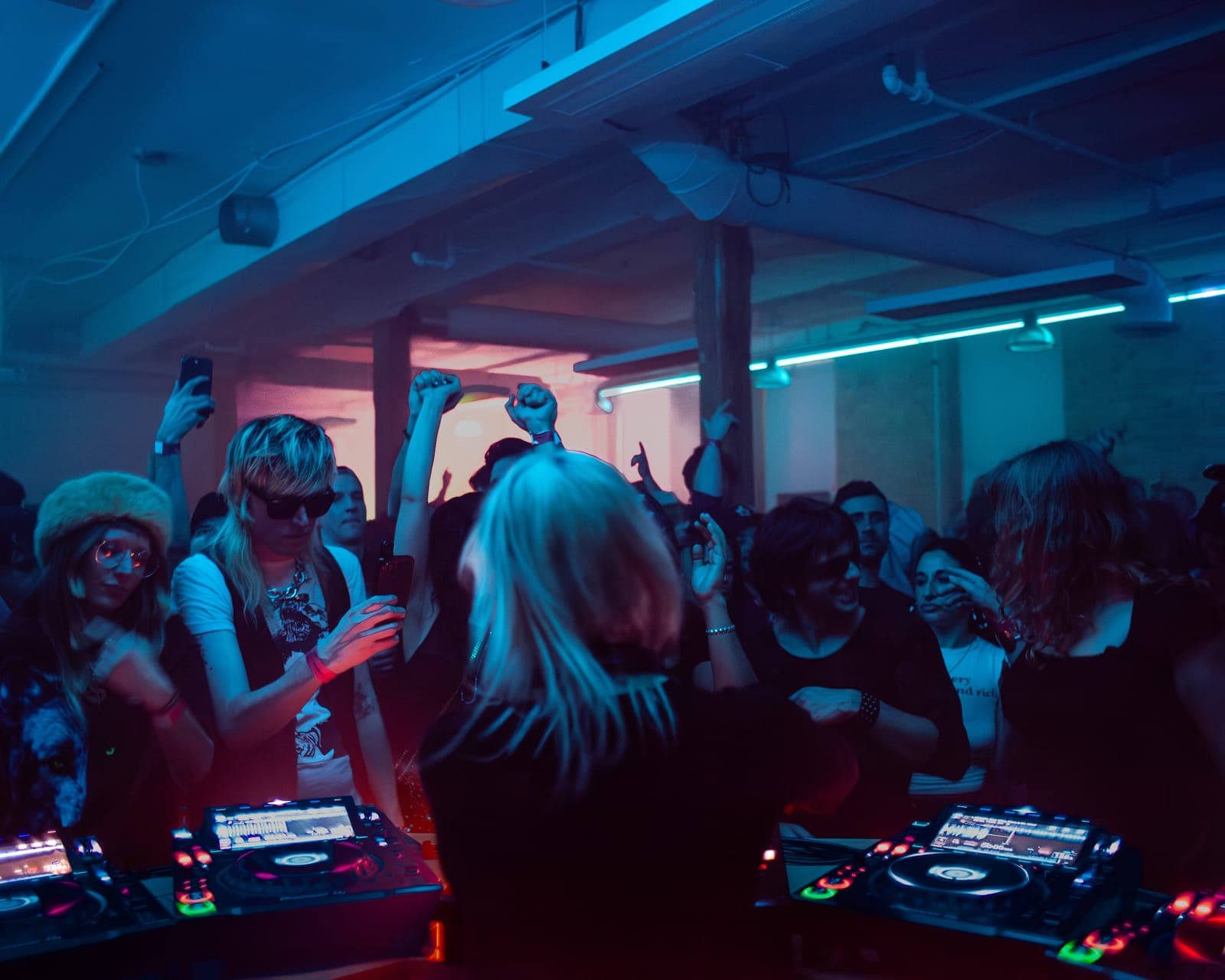The crowd dances with arms raised in blue and red light during Uffie's set at Rhythm in Toronto